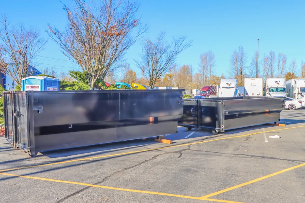 Professional dumpster rental service with roll-off container on residential driveway in Lyman